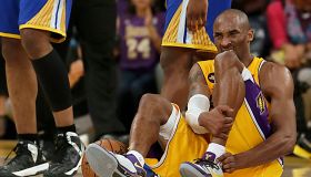 Kobe Bryant writhes in pain on the court late in the game against the Warriors at Staples Center.
