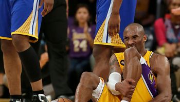 Kobe Bryant writhes in pain on the court late in the game against the Warriors at Staples Center.